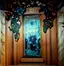 Decorative interior mural - wine cellar entrance featuring painted grape vines and floral motifs with 'VINO' lettering professionally restored